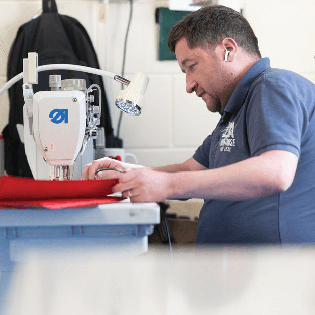 Craftsman stitching bags in Montrose workshop