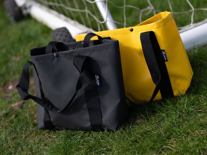 Montrose yellow and black tote bags on grass